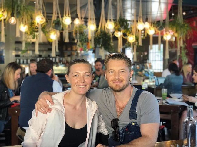 Rick Cosnett as seen while smiling for a picture alongside Michelle Alexandra at The Rose Venice in February 2020 (Rick Cosnett / Instagram) Rick Cosnett as seen while smiling for a picture alongside Michelle Alexandra at The Rose Venice in February 2020